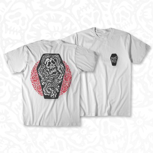 White graphic t-shirt made in Canada from a soft 100% ring-spun cotton, featuring a bold hand-drawn design of a skull in a coffin surrounded by snakes and flowers, screen printed in black and red ink. Perfect for those who appreciate lowbrow, tattoo-style artwork.