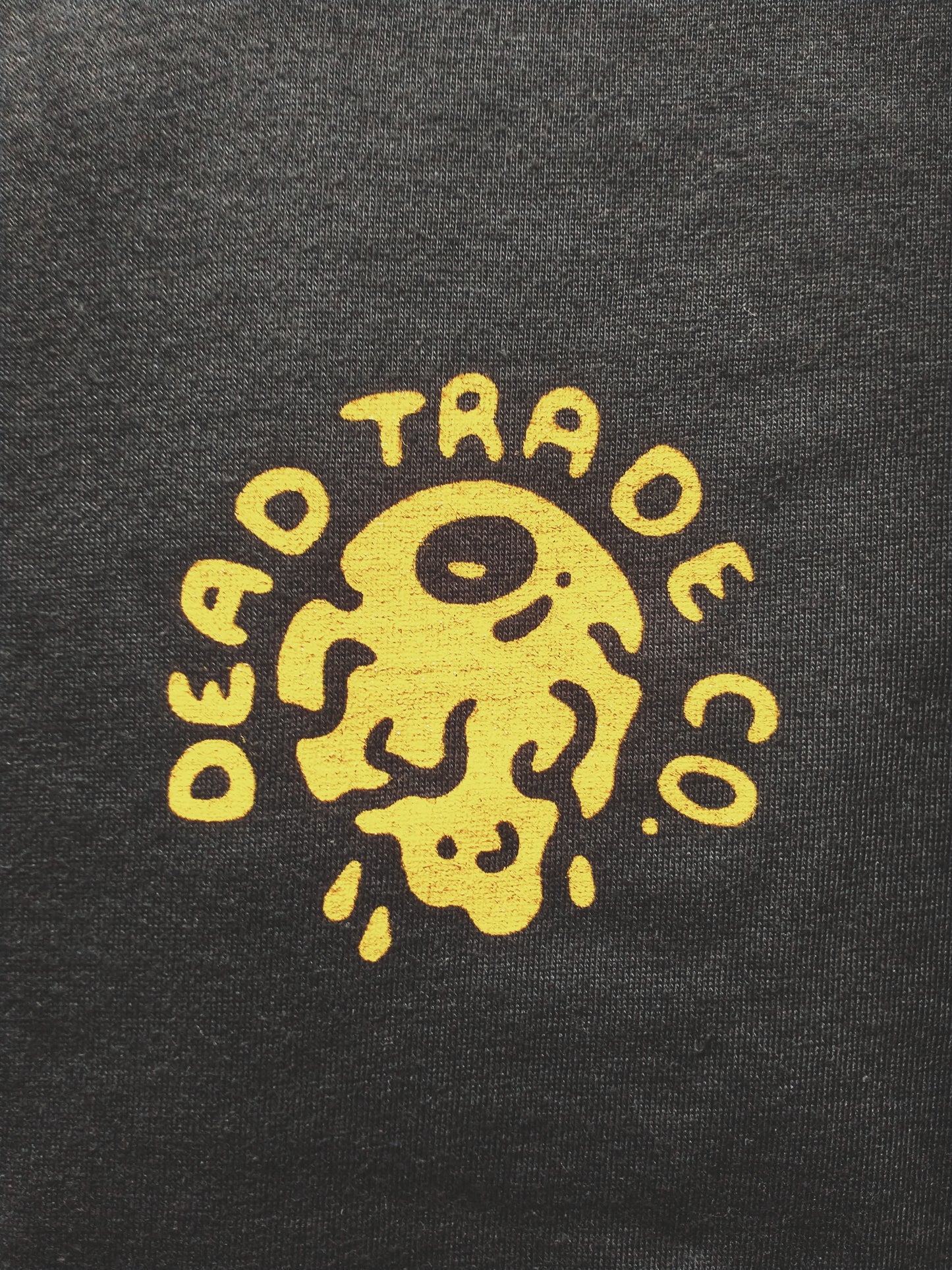 Charcoal graphic t-shirt made in Canada from a soft 50/50 poly-cotton blend, featuring a bold hand-drawn design of an eagle pulling eyeballs from a skull, screen printed in vibrant yellow ink. Perfect for those who appreciate lowbrow, edgy artwork.