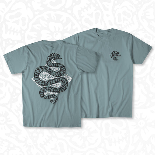 Sage graphic t-shirt made in Canada from a soft 50/50 poly-cotton blend, featuring a bold hand-drawn design of a snake with skull-patterned skin, surrounded by flowers, screen printed in black and white ink. Perfect for those who appreciate lowbrow, tattoo-style artwork.