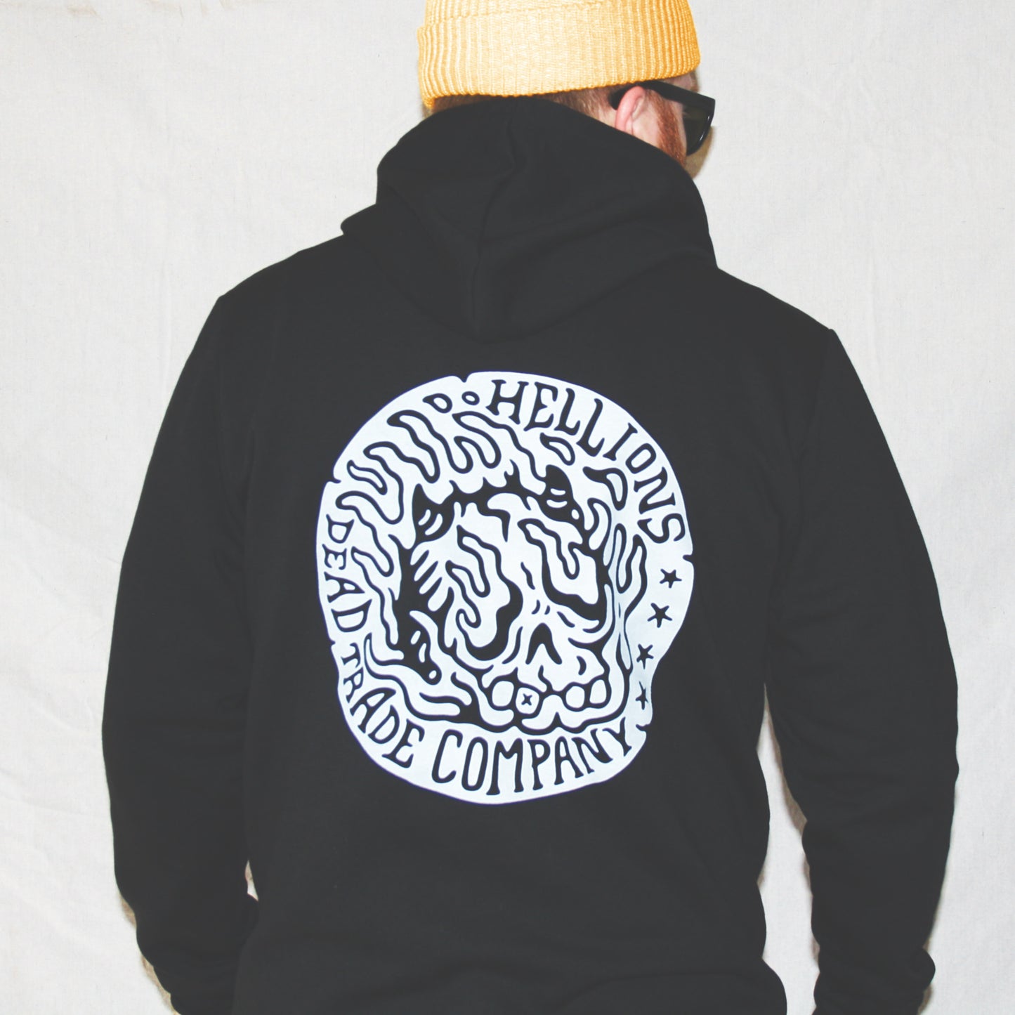 Black colour, high-quality, made-in-Canada hoodie featuring a hand-drawn flaming skull badge screen printed in white on the back. Crafted with 50/50 ring-spun poly/cotton fleece, soft feel, reduced pilling, and durability. Unisex size, 14oz, perfect for cold Canadian winters.