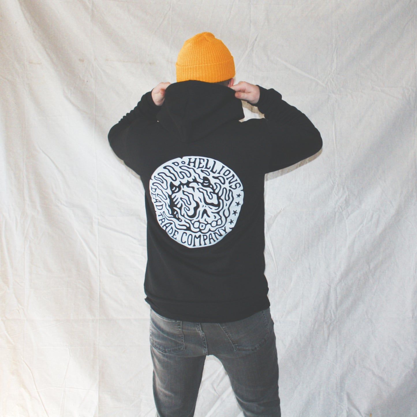 Black colour, high-quality, made-in-Canada hoodie featuring a hand-drawn flaming skull badge screen printed in white on the back. Crafted with 50/50 ring-spun poly/cotton fleece, soft feel, reduced pilling, and durability. Unisex size, 14oz, perfect for cold Canadian winters.