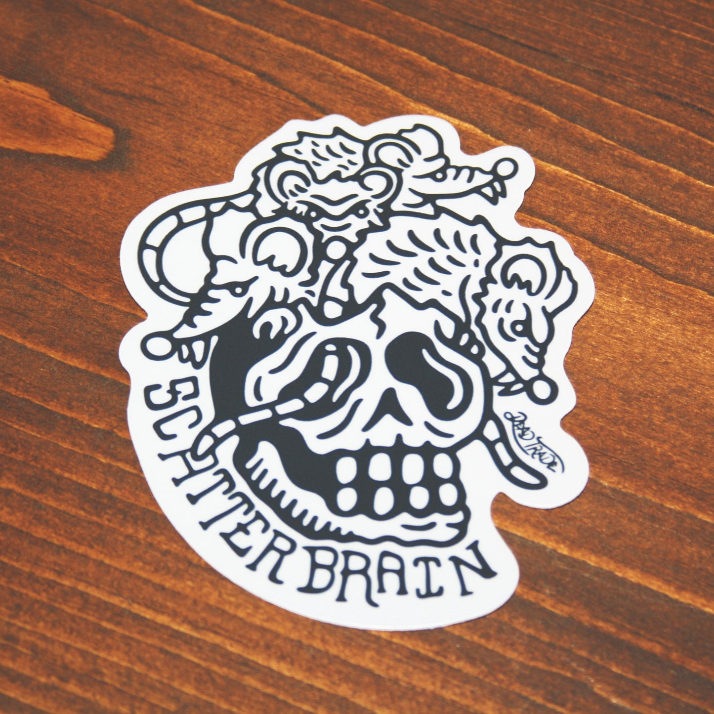 5-piece vinyl sticker pack with hand-drawn designs: rose & dagger, screw head, scatterbrain, grease monkey, and zombie in a coffin. Durable, matte finish, weather-resistant, waterproof, and dishwasher-safe. Each 4x3” sticker sticks strong to most surfaces. Made in Canada.