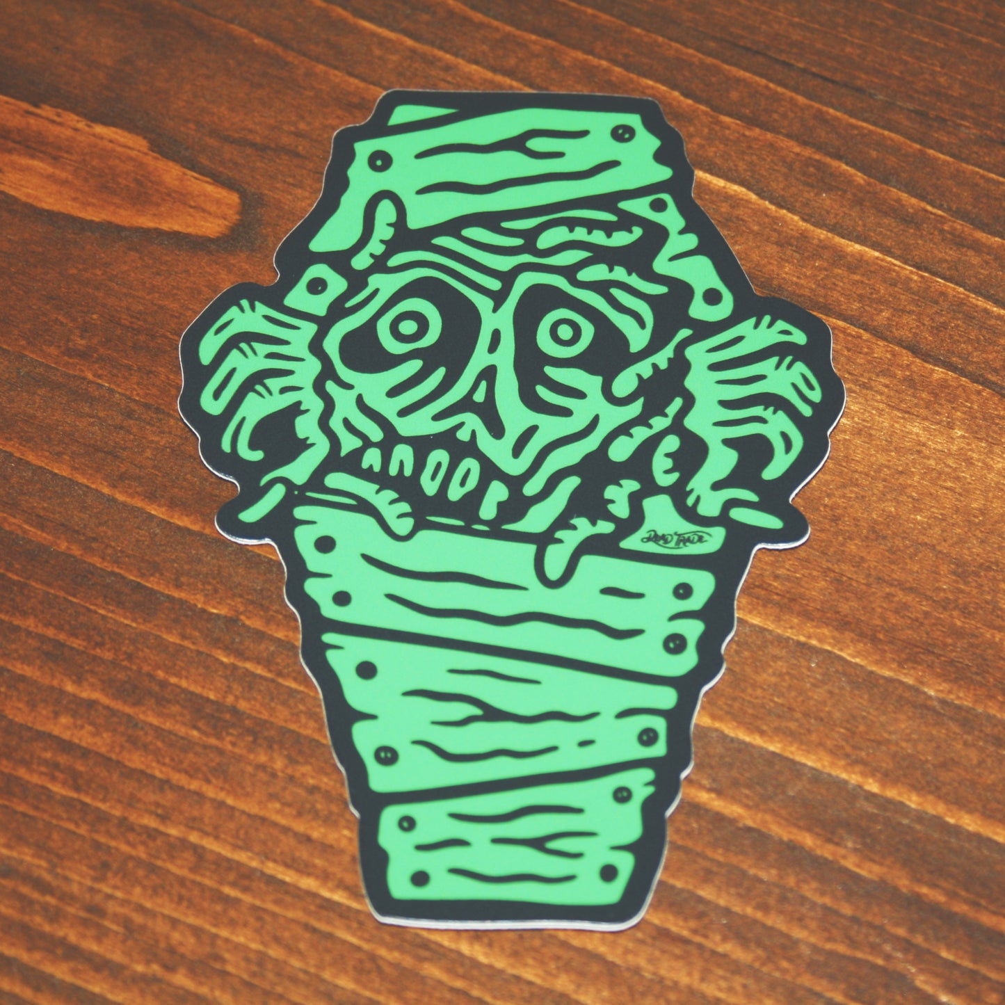 5-piece vinyl sticker pack with hand-drawn designs: rose & dagger, screw head, scatterbrain, grease monkey, and zombie in a coffin. Durable, matte finish, weather-resistant, waterproof, and dishwasher-safe. Each 4x3” sticker sticks strong to most surfaces. Made in Canada.