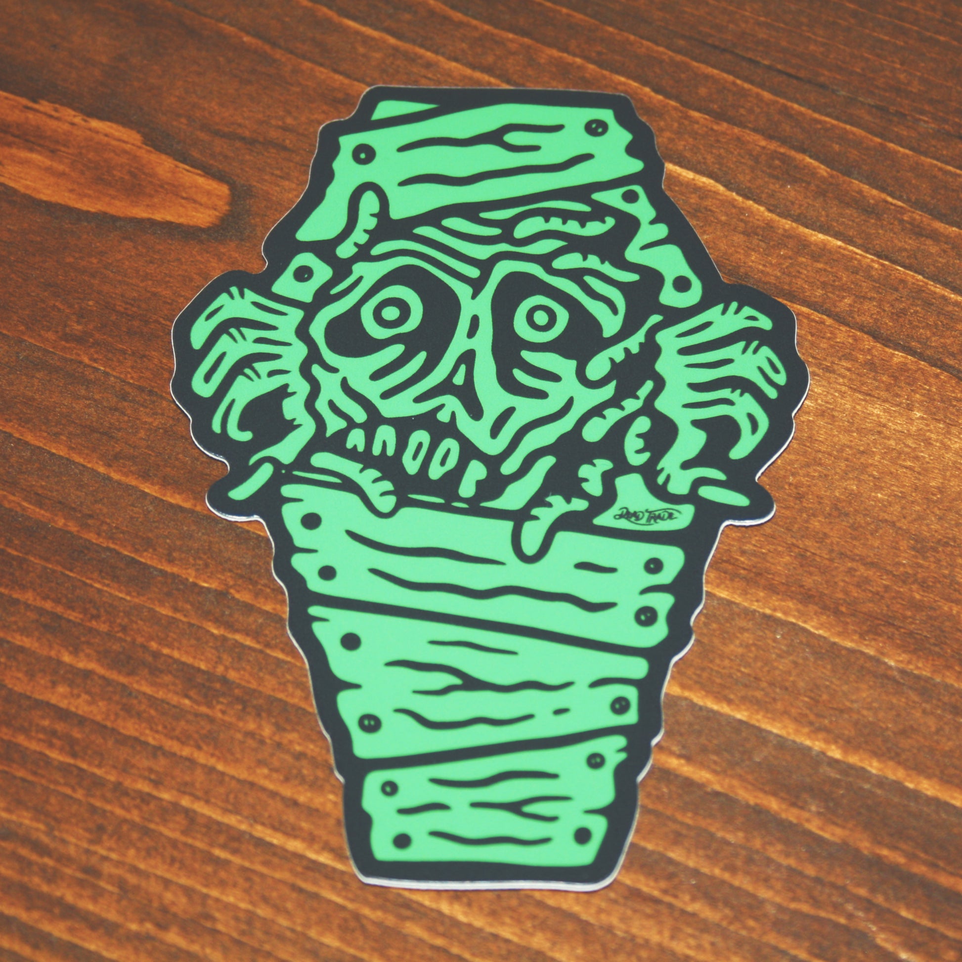 5-piece vinyl sticker pack with hand-drawn designs: rose & dagger, screw head, scatterbrain, grease monkey, and zombie in a coffin. Durable, matte finish, weather-resistant, waterproof, and dishwasher-safe. Each 4x3” sticker sticks strong to most surfaces. Made in Canada.